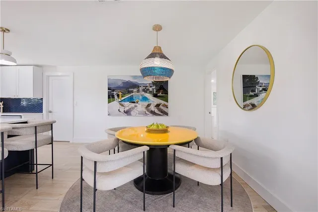 a dining room with table and chairs