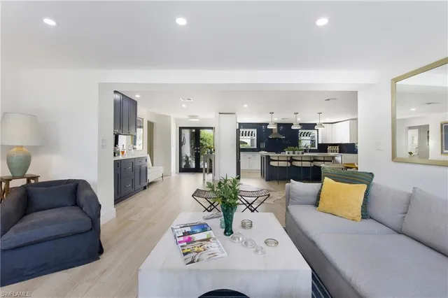 a living room with furniture kitchen view and a table
