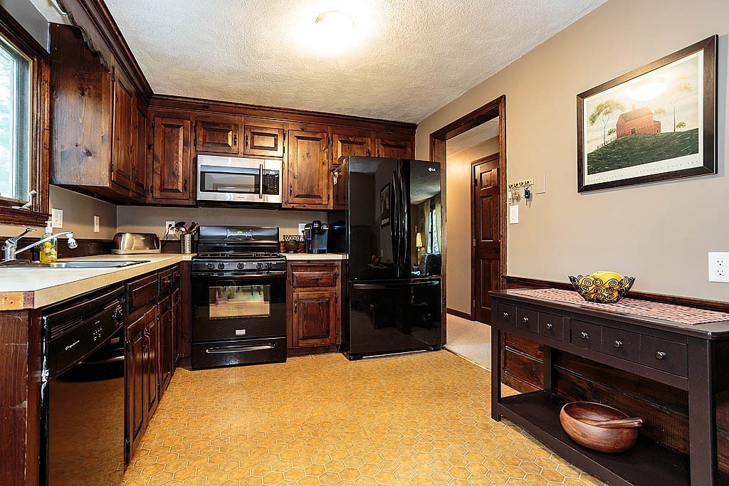 4 Chippewa Road Westford, MA 01886 - Photo 11 of 25 a kitchen with a refrigerator stove and sink