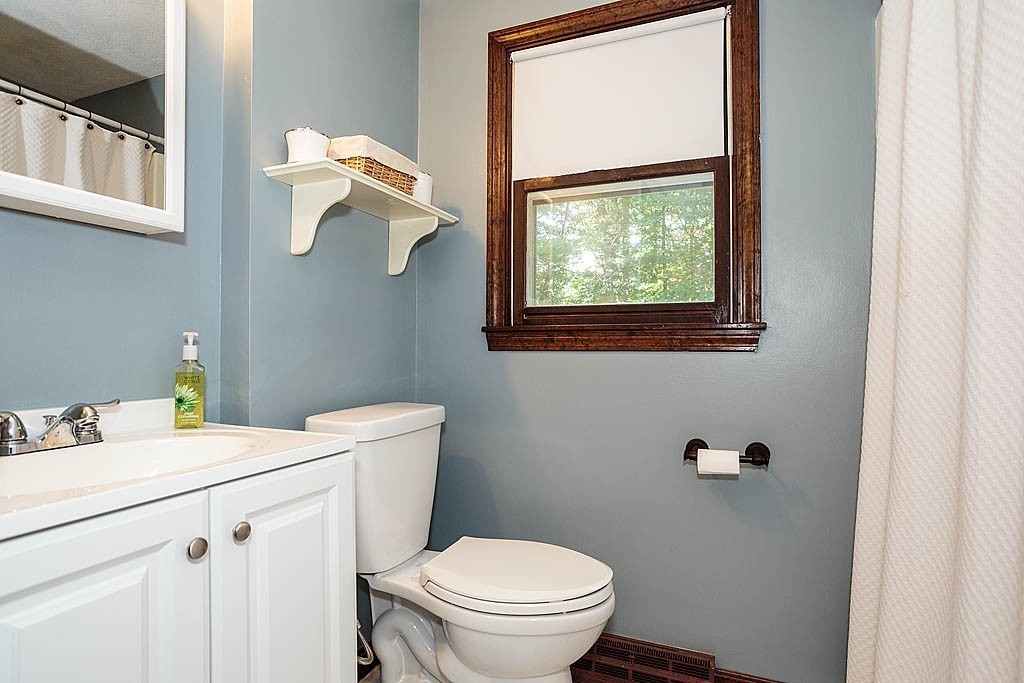4 Chippewa Road Westford, MA 01886 - Photo 13 of 25 a bathroom with a sink a toilet and a mirror