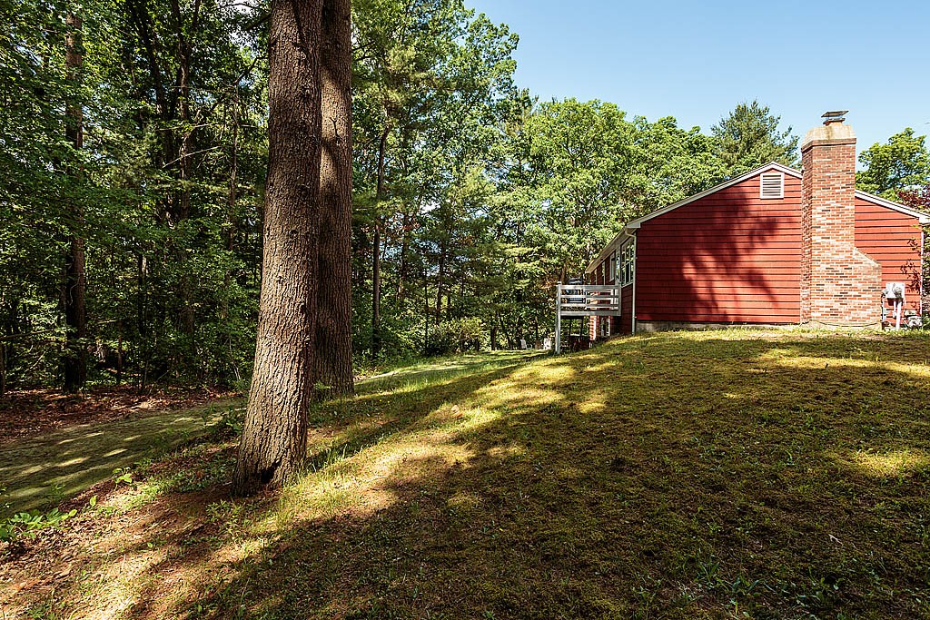 4 Chippewa Road Westford, MA 01886 - Photo 24 of 25 a view of a wooden house with a yard