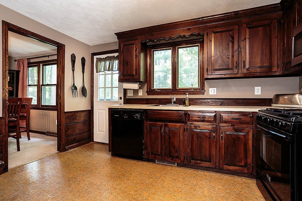 4 Chippewa Road Westford, MA 01886 - Photo 4 of 25 a kitchen with a sink stove and cabinets