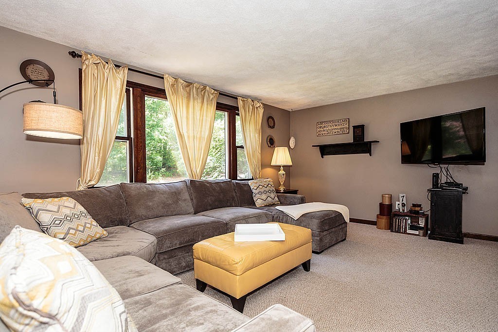 4 Chippewa Road Westford, MA 01886 - Photo 7 of 25 a living room with furniture and a flat screen tv
