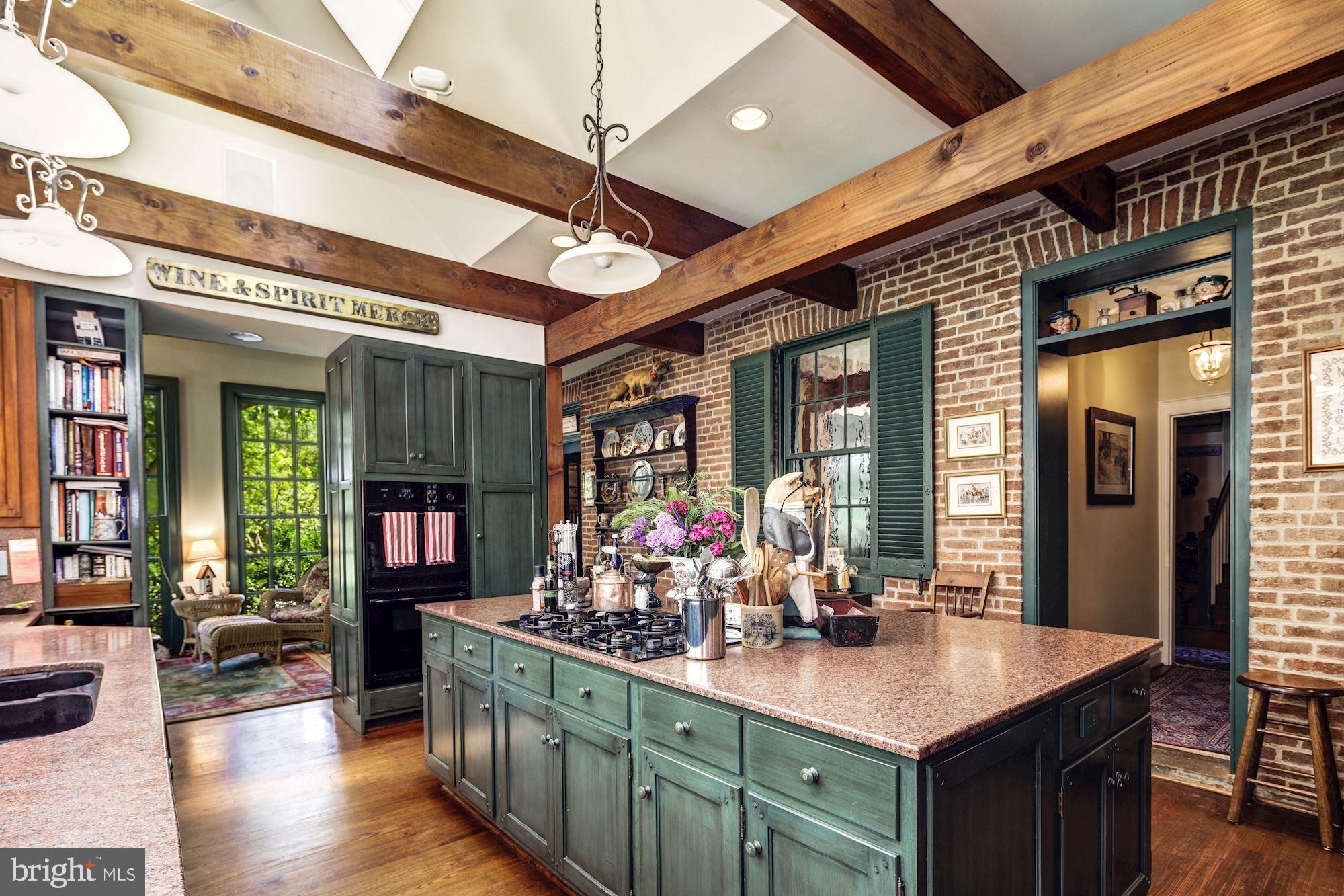 13032 Highland Road Highland, MD 20777 - Photo 23 of 114 a kitchen with stainless steel appliances wooden cabinets a dining table and chairs with wooden floor