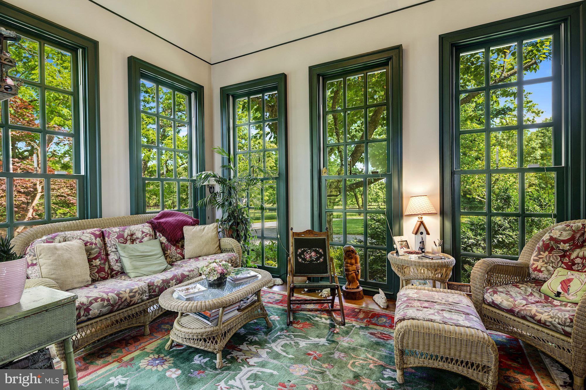 13032 Highland Road Highland, MD 20777 - Photo 29 of 114 a living room with furniture and floor to ceiling windows