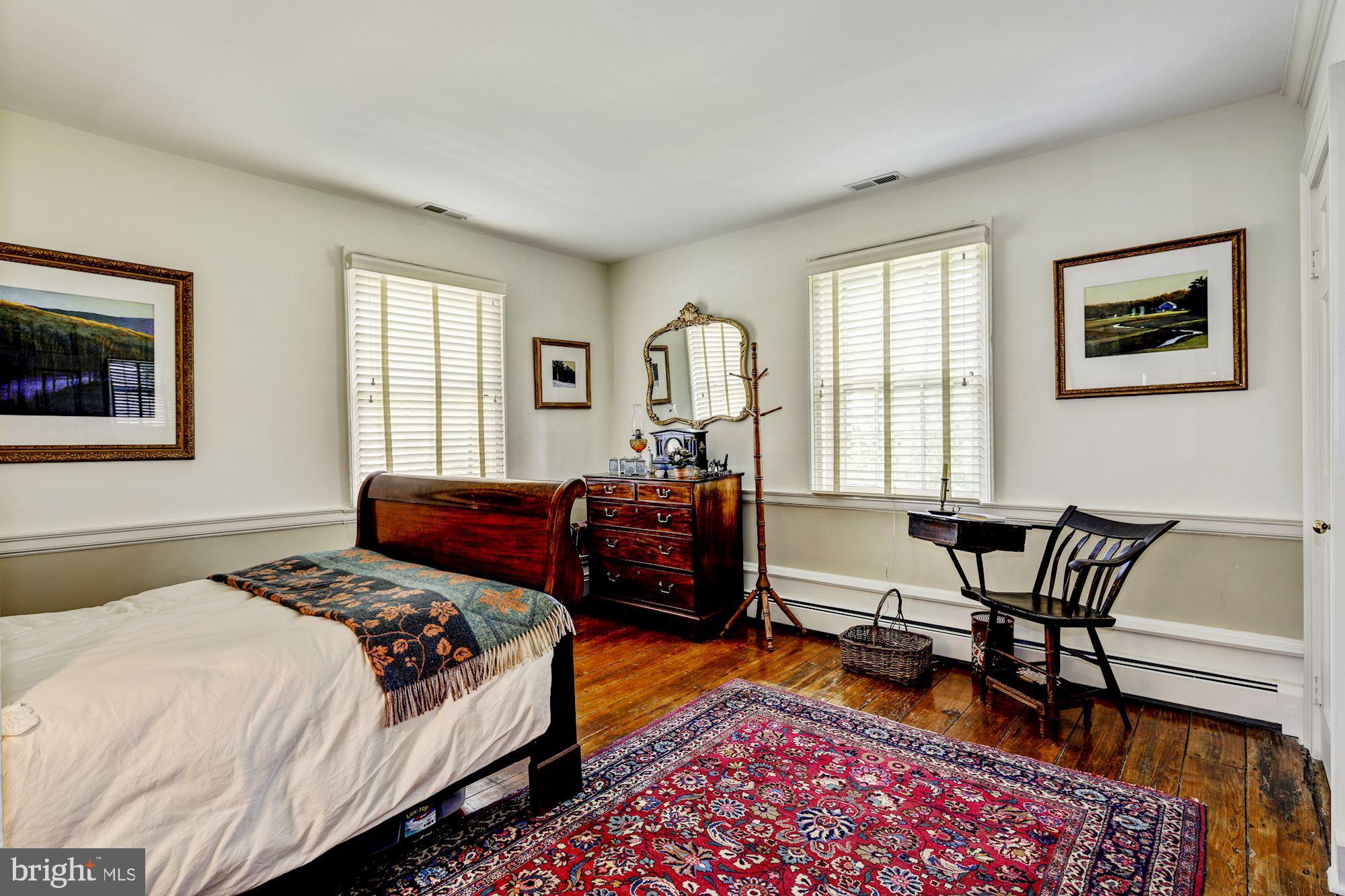 13032 Highland Road Highland, MD 20777 - Photo 39 of 114 a bedroom with a bed and wooden floor