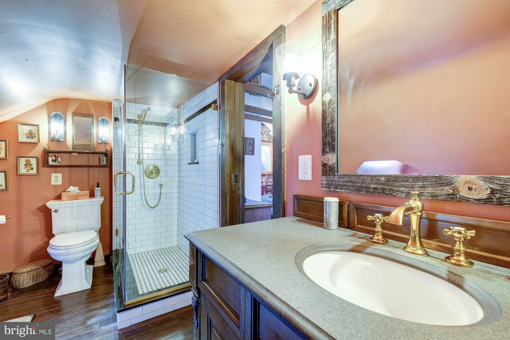 13032 Highland Road Highland, MD 20777 - Photo 91 of 114 a bathroom with a granite countertop sink a toilet a mirror and shower