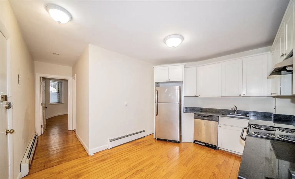 1728 Beacon Street, Unit B Brookline, MA 02445 - Photo 1 of 10 a kitchen with a refrigerator a stove top oven a sink and dishwasher