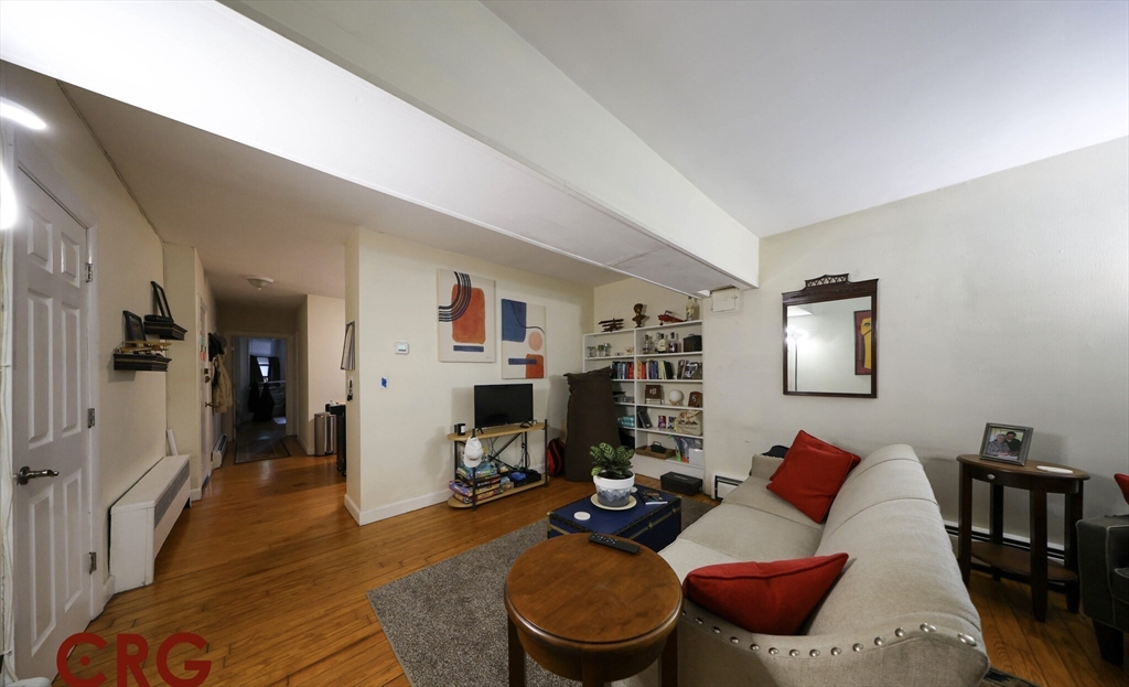 1728 Beacon Street, Unit B Brookline, MA 02445 - Photo 6 of 10 a living room with furniture and wooden floor