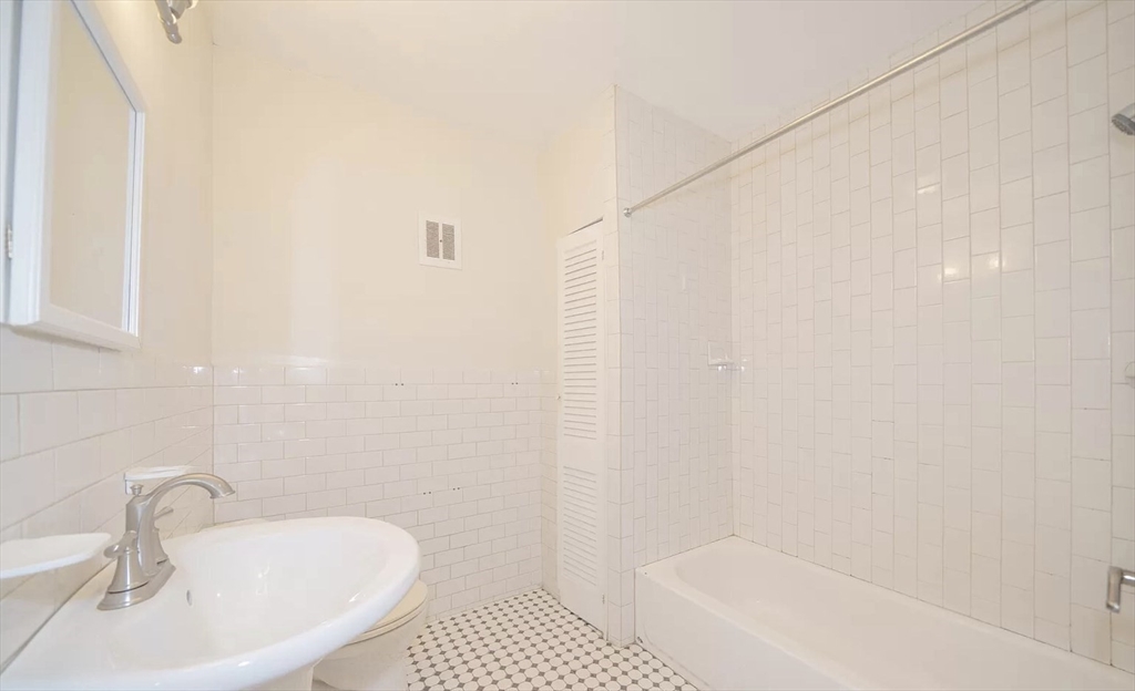 1728 Beacon Street, Unit B Brookline, MA 02445 - Photo 7 of 10 a bathroom with a sink and a bathtub