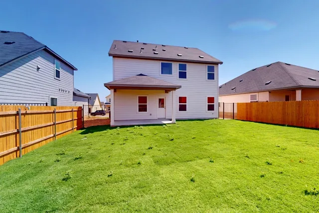 a view of a backyard with table and chairs