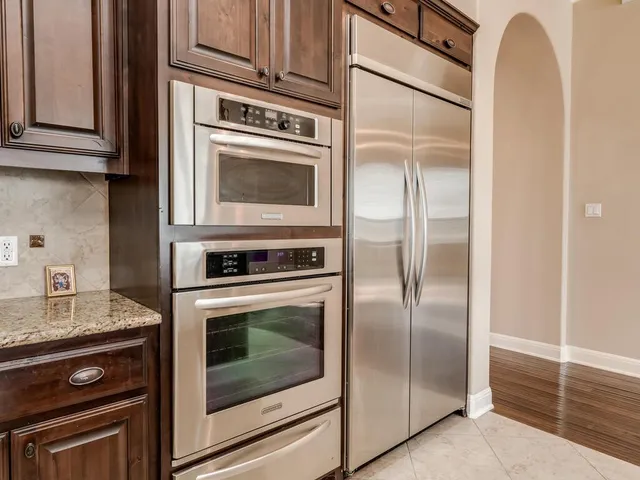 a kitchen with cabinets and stainless steel appliances