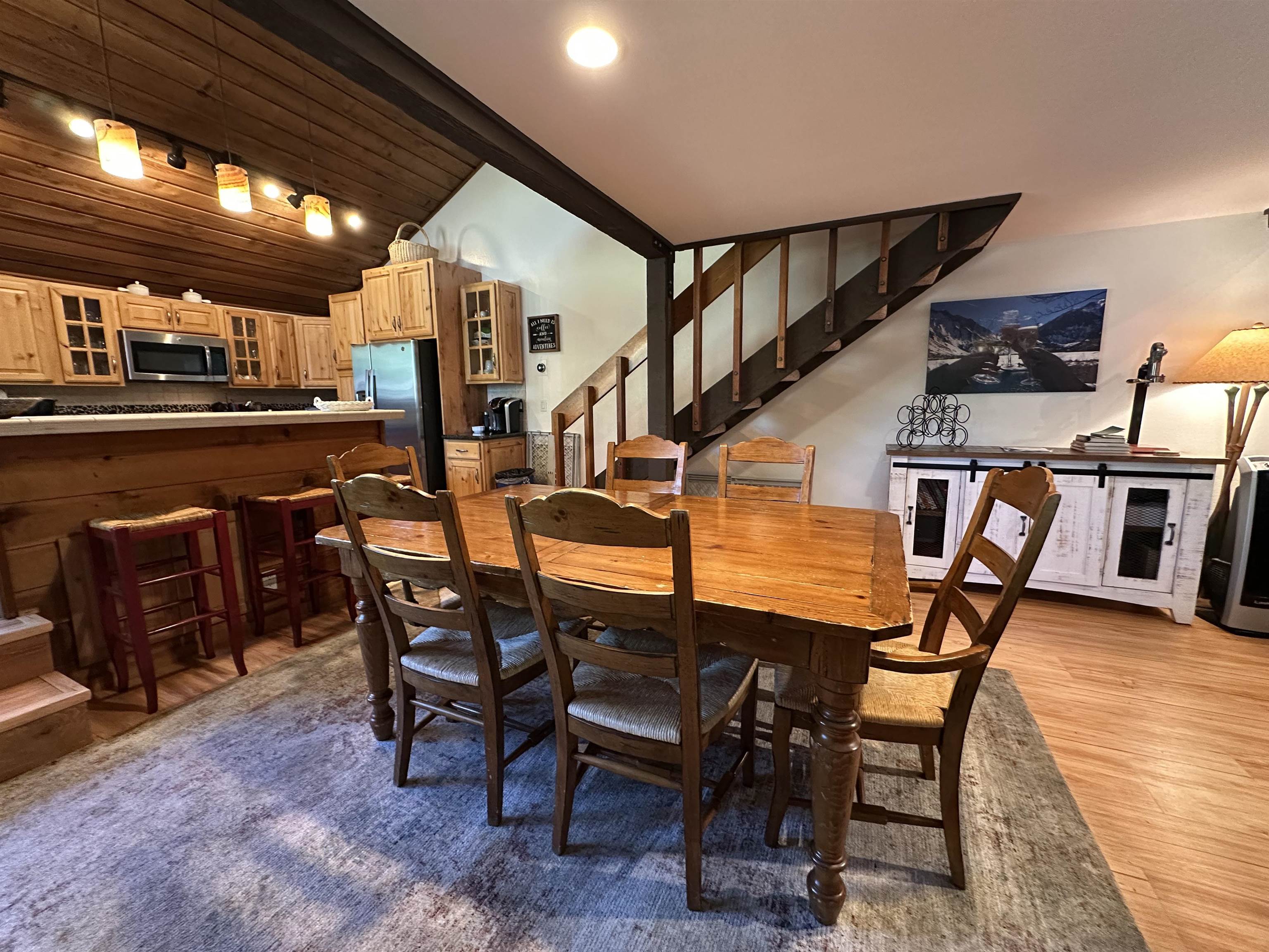 315 Fascination, Unit 315 Mammoth Lakes, CA 93546 - Photo 23 of 44 Vaulted wood-paneled ceiling with track lighting illuminates a dining area featuring wood-finish flooring