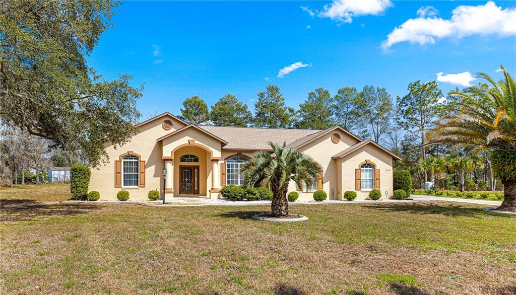11267 Southwest 51st Avenue Ocala, FL 34476 - Photo 1 of 1 a front view of a house with a yard