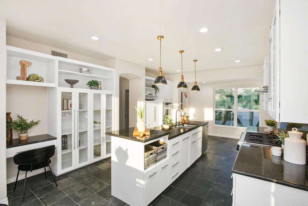 3325 Jasmine Crest Encinitas, CA 92024 - Photo 17 of 45 a kitchen with stainless steel appliances granite countertop a stove a sink and a refrigerator