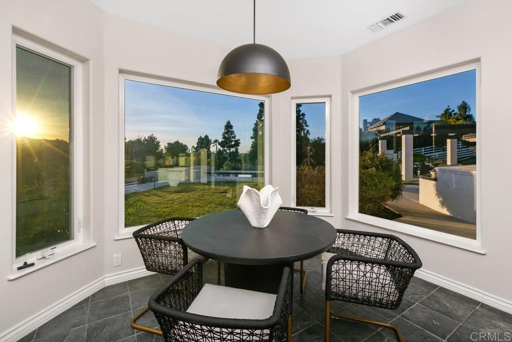 3325 Jasmine Crest Encinitas, CA 92024 - Photo 19 of 45 a view of a dining room with furniture wooden floor and a floor to ceiling window