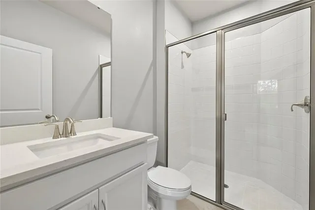 an empty room with white cabinet and windows