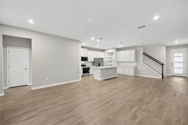 a kitchen with white cabinets stainless steel appliances and sink