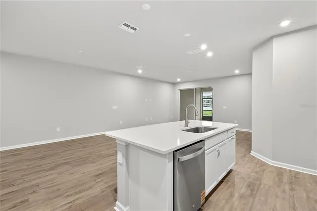 a kitchen with a refrigerator sink and stove