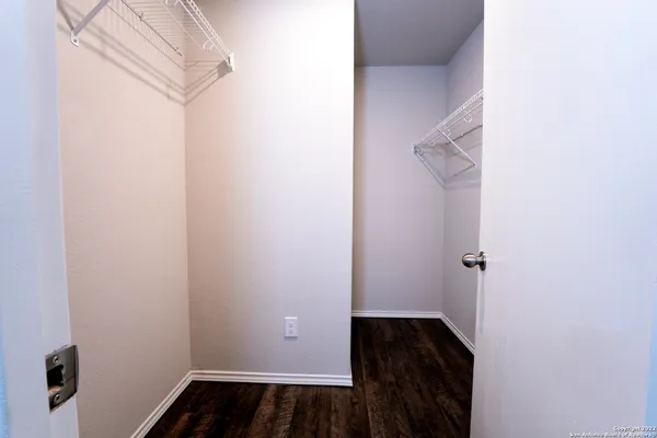 a view of a small space with wooden floor and a window