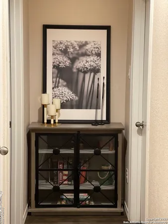 a backyard of a house with wooden fence and large trees
