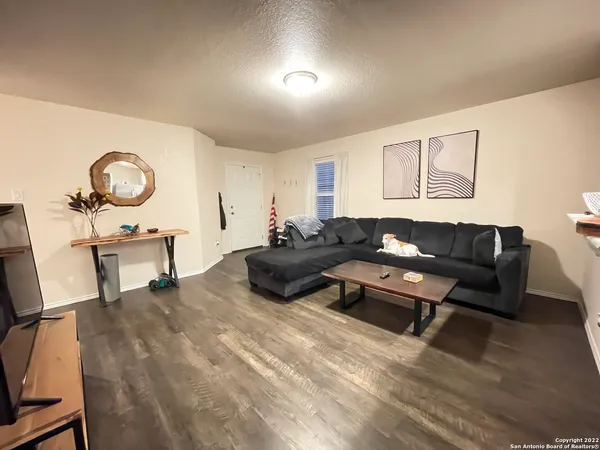 a bed sitting in a room next to a window and a chair