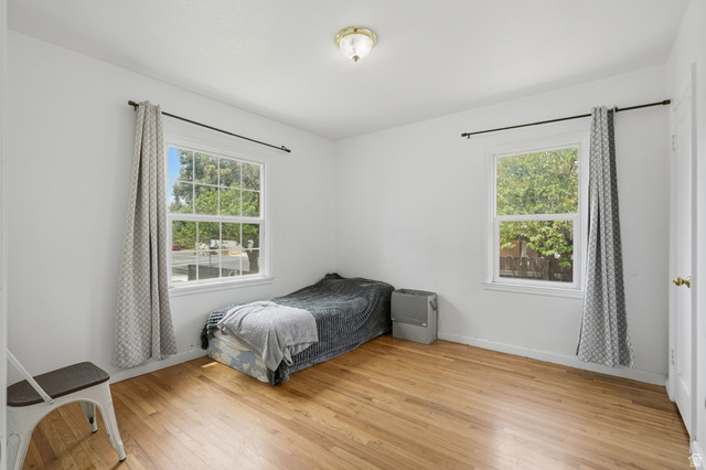 707 East 150 South Provo, UT 84606 - Photo 12 of 31 Bedroom #1 Bright interior space featuring wood-finish flooring, white walls, and two multi-pane windows