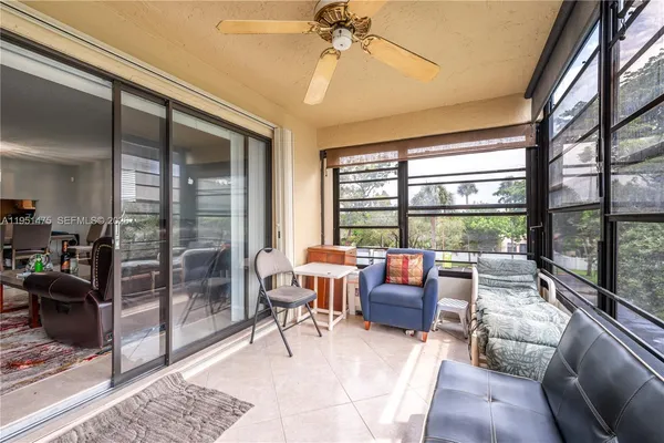 a living room with furniture and a floor to ceiling window