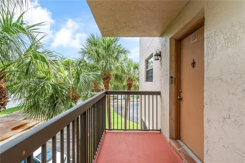 a view of balcony with wooden floor