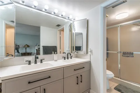 a bathroom with a sink double vanity and a toilet