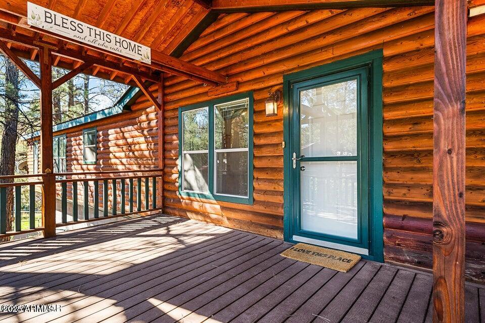 2421 West Thornton Road Show Low, AZ 85901 - Photo 6 of 48 a porch with wooden floor and city view