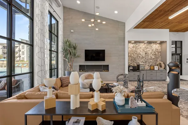 a living room with fireplace furniture and a large window