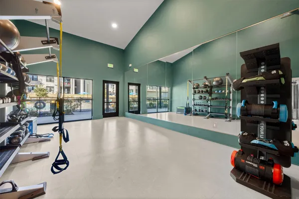 a room with gym equipment and a large window