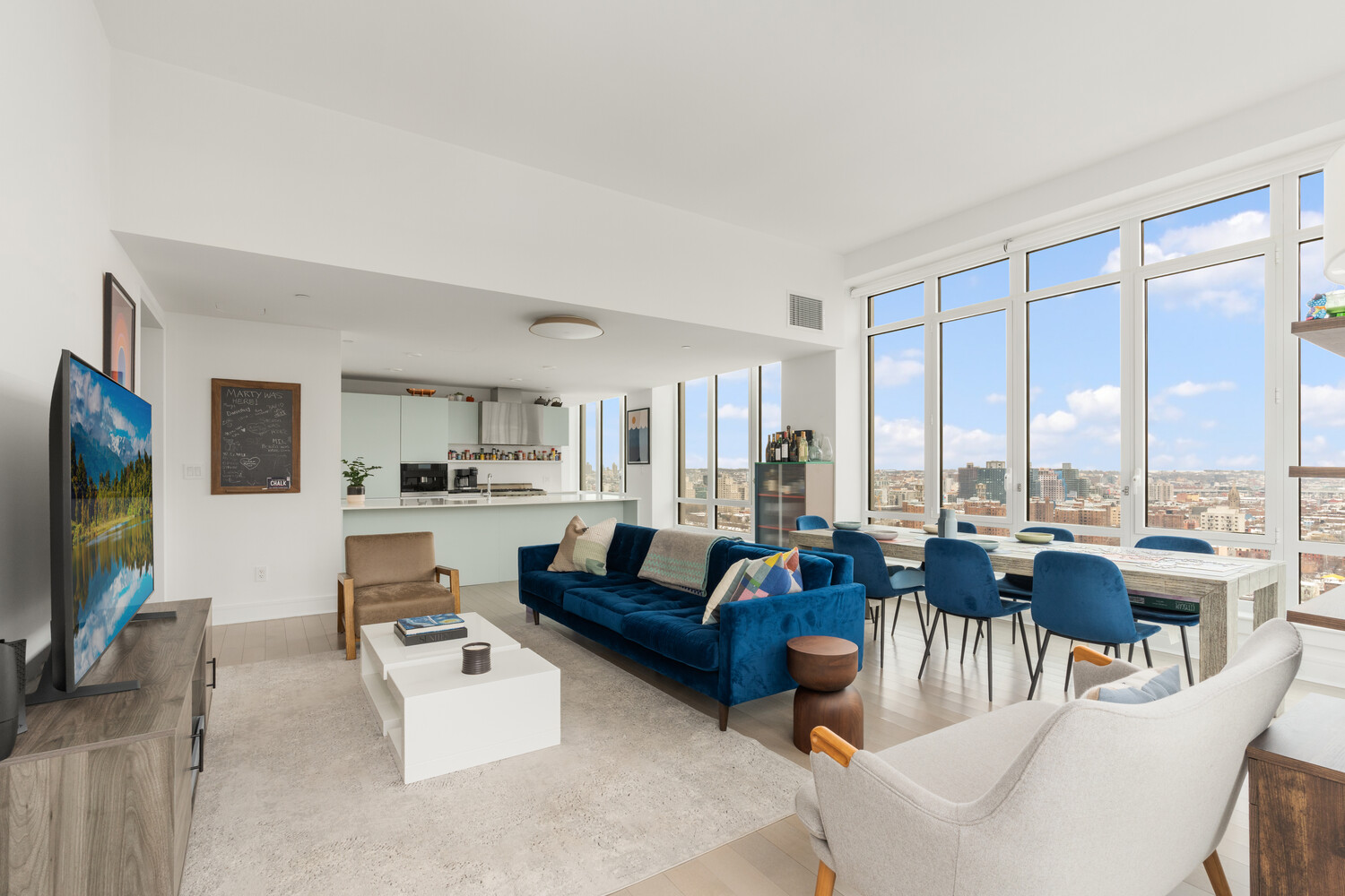 265 State Street, Unit PH1 Brooklyn, NY 11201 - Photo 1 of 17 a living room with furniture a flat screen tv and a large window