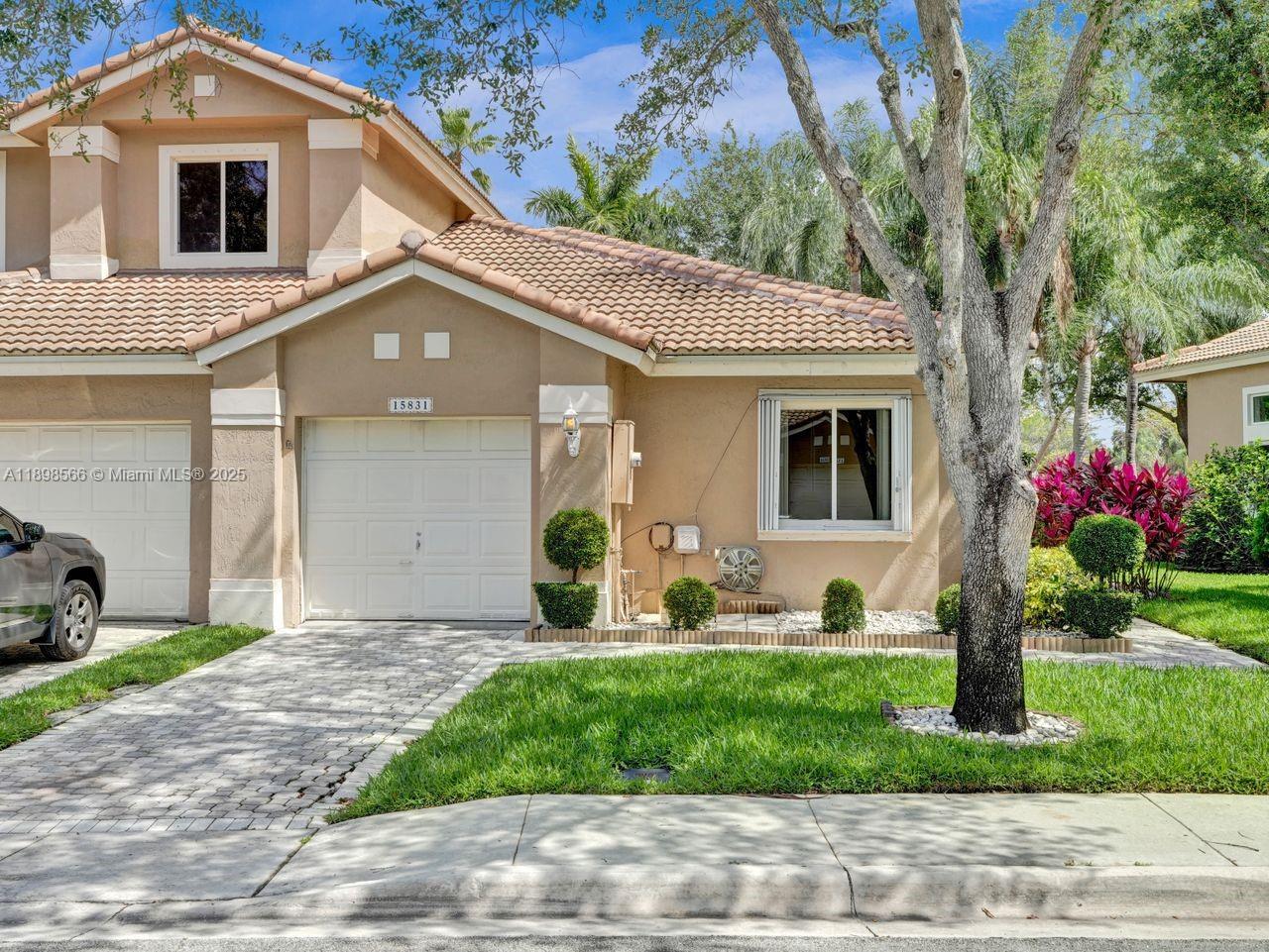 a front view of a house with garden