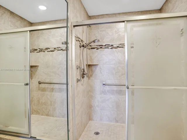 a bathroom with a glass shower door