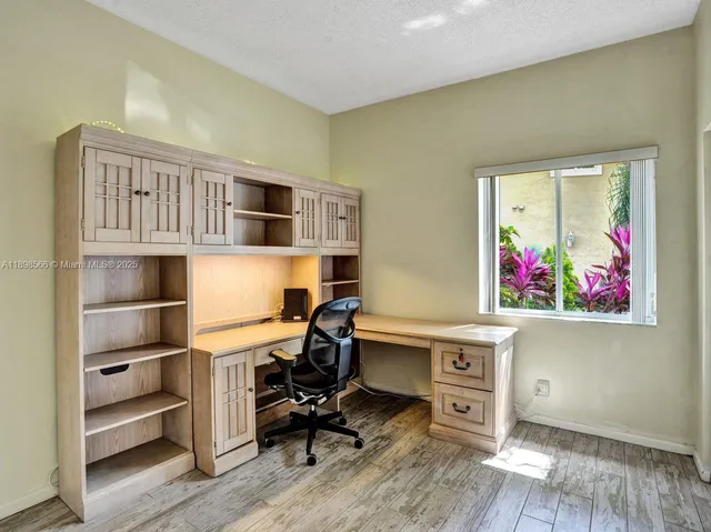 a workspace with furniture wooden floor and window