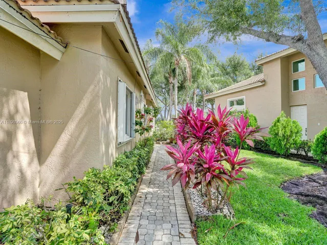 a view of a house with potted plants