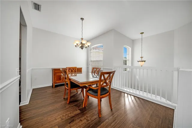 a view of a dining room with furniture wooden floor and chandelier