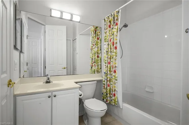 a bathroom with a sink a toilet and shower curtain