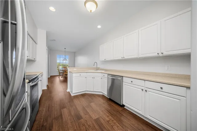 a kitchen with cabinets oven and a dishwasher with wooden floor