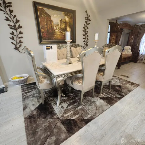 a dining room with furniture and wooden floor