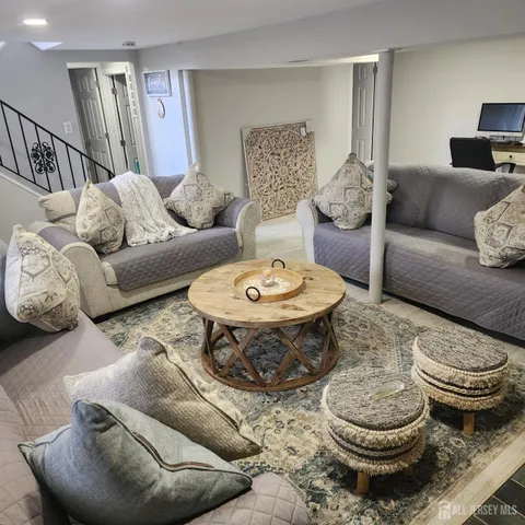 a living room with furniture and a dining table