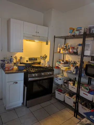 a kitchen with stainless steel appliances granite countertop a stove and a sink