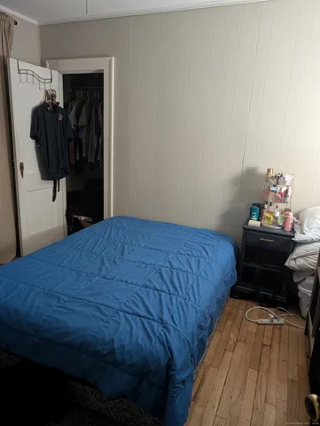 a bedroom with a bed and a closet