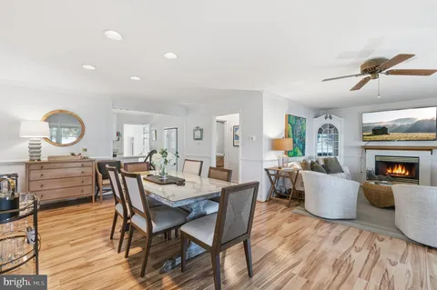a kitchen with white cabinets a sink dishwasher and a stove with wooden floor