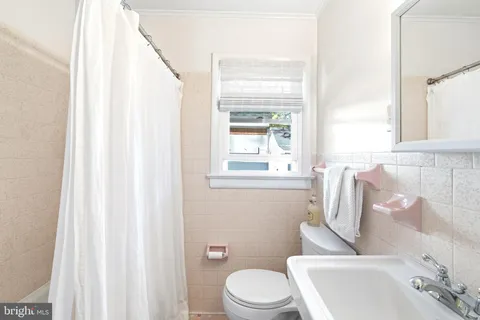 a spacious bedroom with a bed and a chandelier