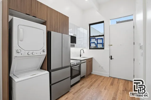 a kitchen with stainless steel appliances a refrigerator sink and cabinets