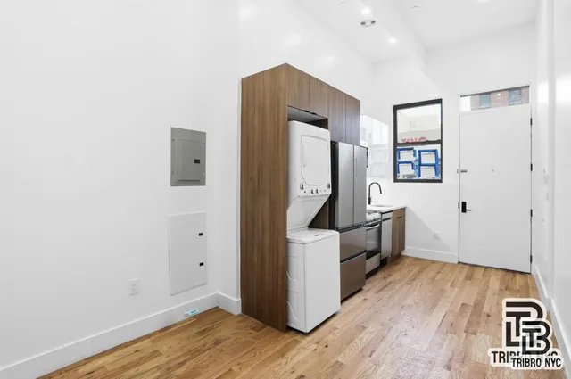 a view of kitchen with a refrigerator and wooden floor