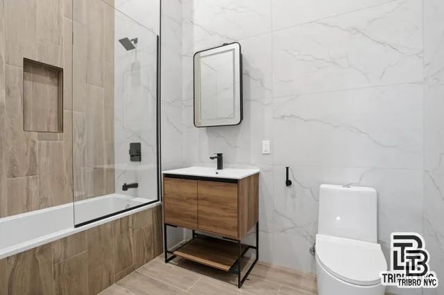 a bathroom with a toilet a sink and mirror